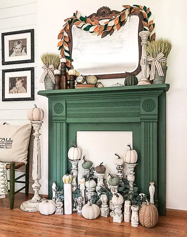 Cozy fall mantel decorated with pumpkins, autumn leaves, and warm-toned candles, showcasing creative fall mantel ideas for 2025.