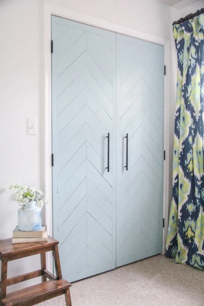 A beautifully transformed closet door with a modern design, featuring sleek panels and a fresh coat of white paint, showcasing a stunning closet door makeover.
