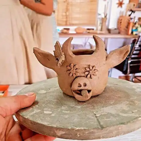 
A collection of handmade clay crafts, including colorful pinch pot planters, textured coil vases, and intricate ceramic mugs, displayed on a rustic wooden table, showcasing creative clay ideas for beginners and advanced crafters in 2025.
