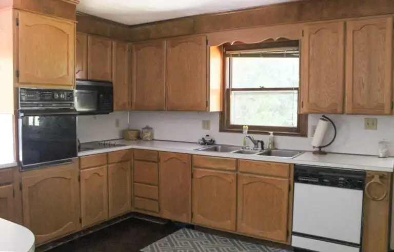 Modern kitchen makeover featuring sleek white cabinets, stainless steel appliances, and a marble countertop with a cozy breakfast nook.
